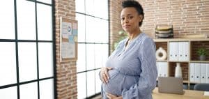 Pregnant black woman at the office