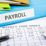 Payroll binder, a weekly time sheet, and a calculator