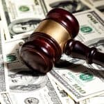 Image of a judge's gavel over cash