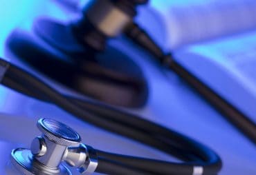 stylized image of a law book, a gavel, and a stethoscope to represent a personal injury law firm