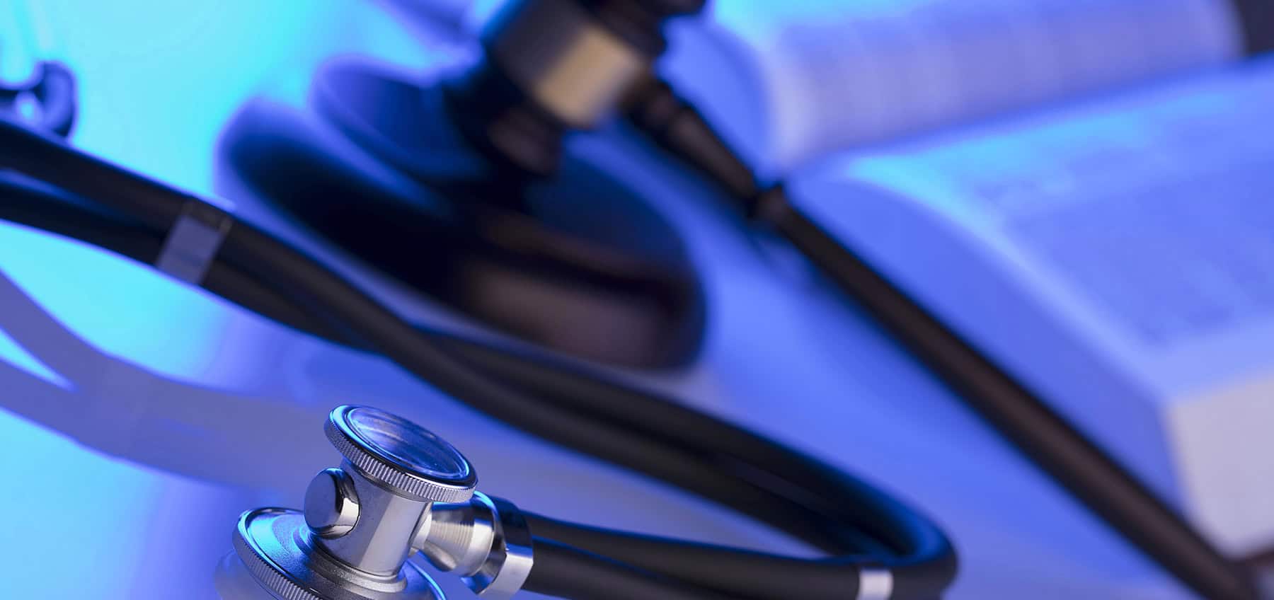 stylized image of a law book, a gavel, and a stethoscope to represent a personal injury law firm