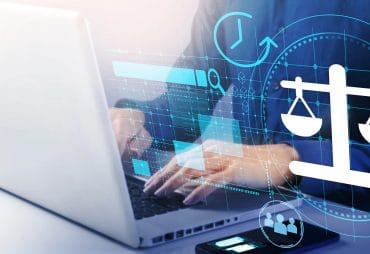 Person typing on a laptop computer with graphical overlay depicting law and financial graphs to represent a Law Firm Fractional CFO