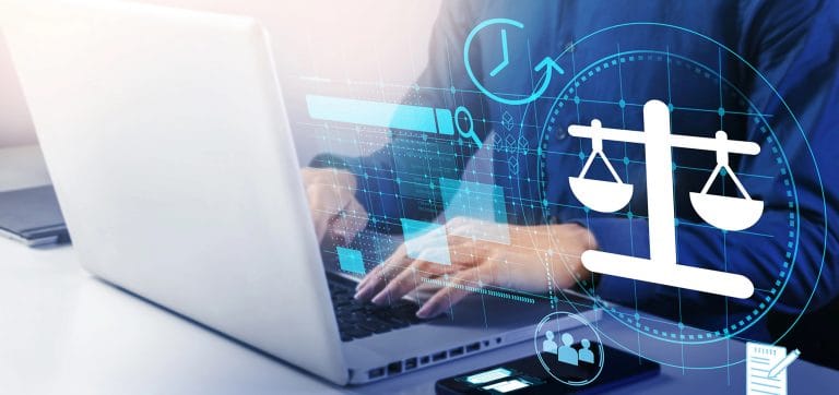 Person typing on a laptop computer with graphical overlay depicting law and financial graphs to represent a Law Firm Fractional CFO